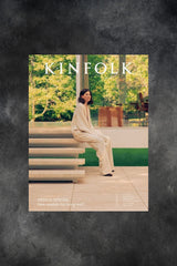 Kinfolk cover issue 51 with woman sitting on elegant stone steps